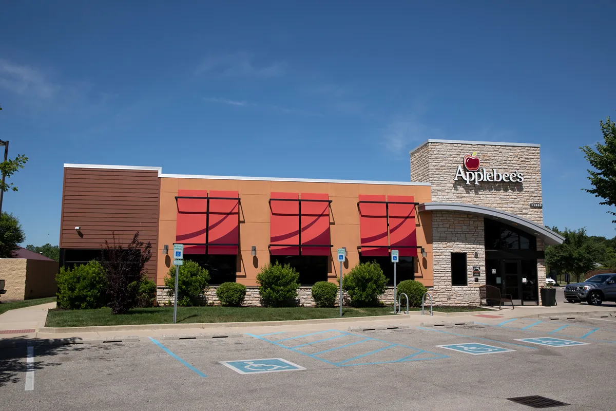 Applebee's restaurant exterior with parking lot, featuring the Flynn Group careers location