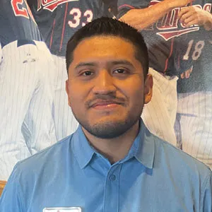 Applebee's team member wear blue shirt smiling in uniform