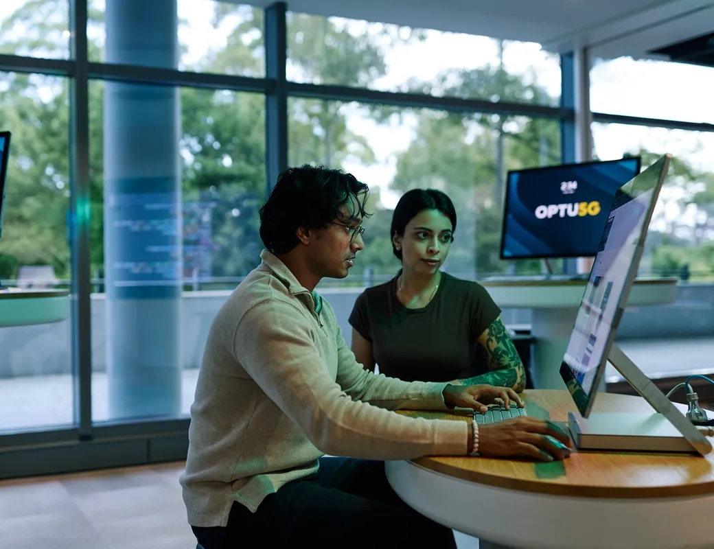Two people interacting with a VR headset in a modern room