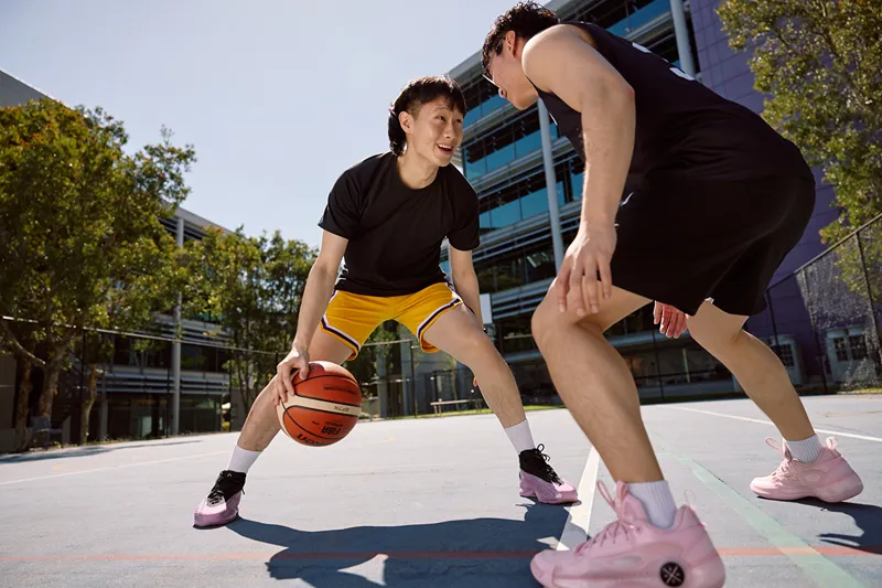 2 people playing basketball