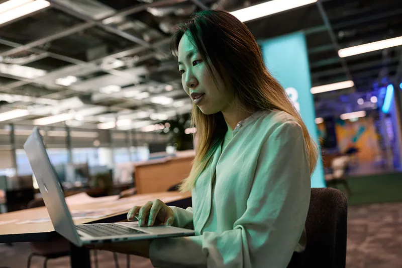 Woman working on a laptop in a modern office