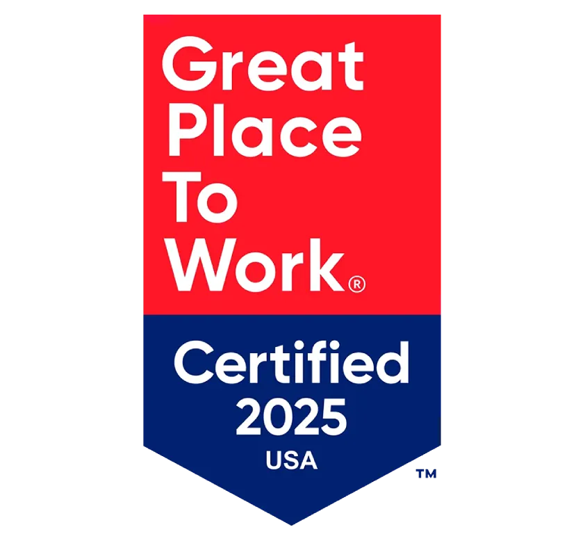 Smiling employees collaborating under a Great Place To Work banner