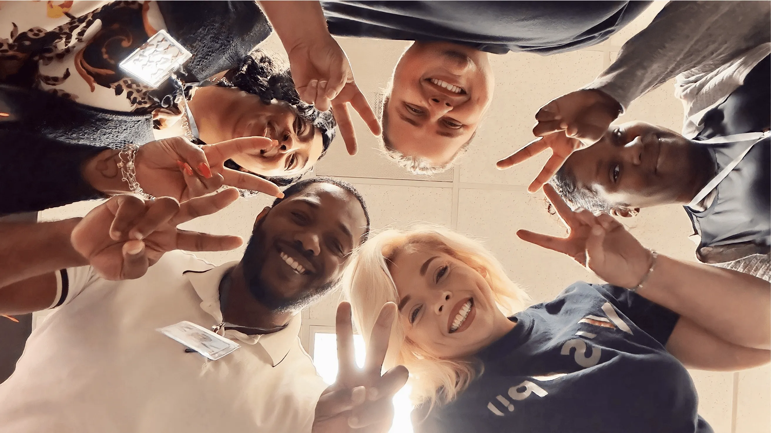Victra team members looking down at camera in a group selfie