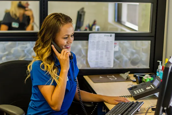 a woman making a phone call at her desk