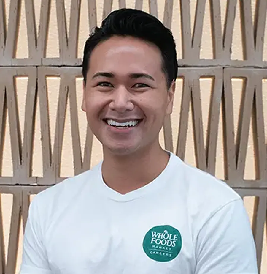 Sean smiling wearing a Whole Foods Market Careers t-shirt.