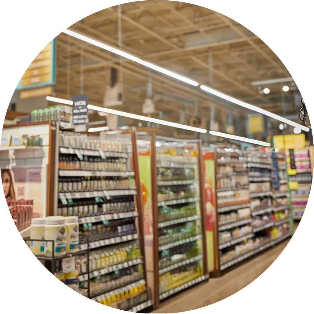 Grocery store aisle with various products on shelves, in a circular cropped view.