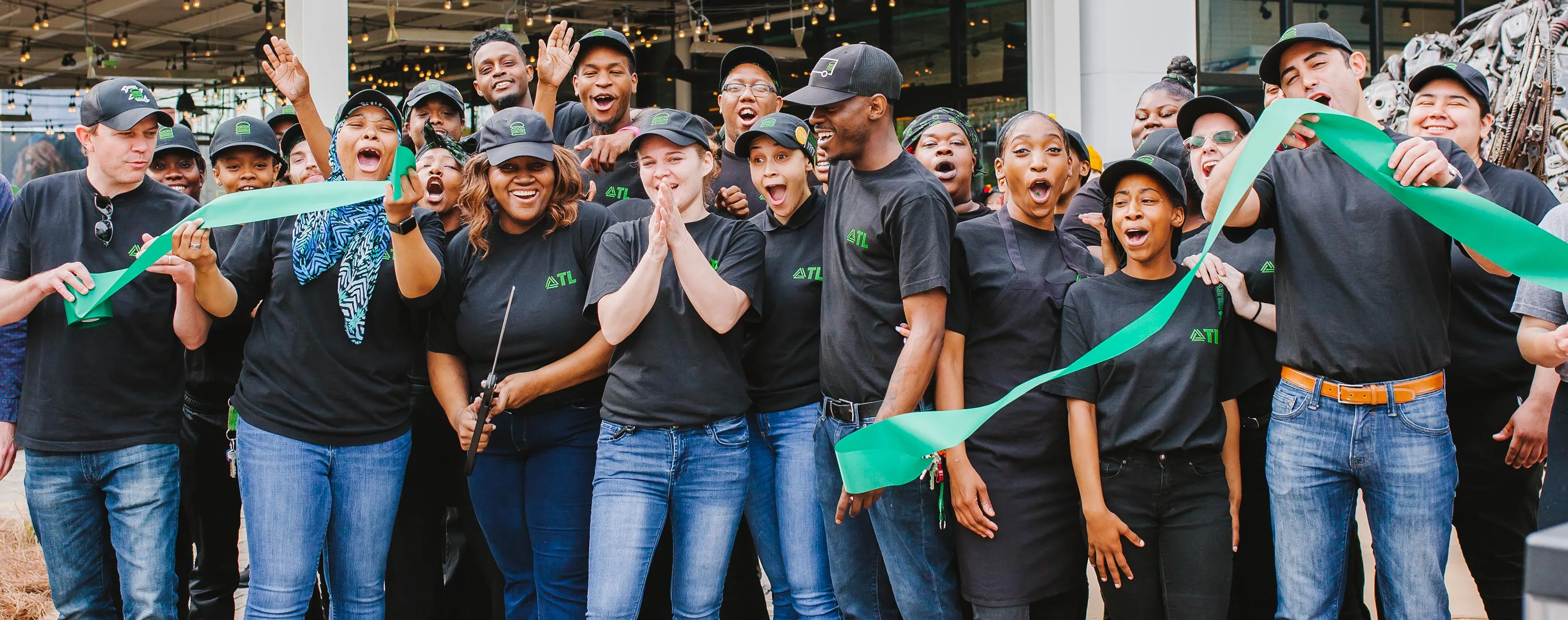 Team cutting a ribbon at a grand opening