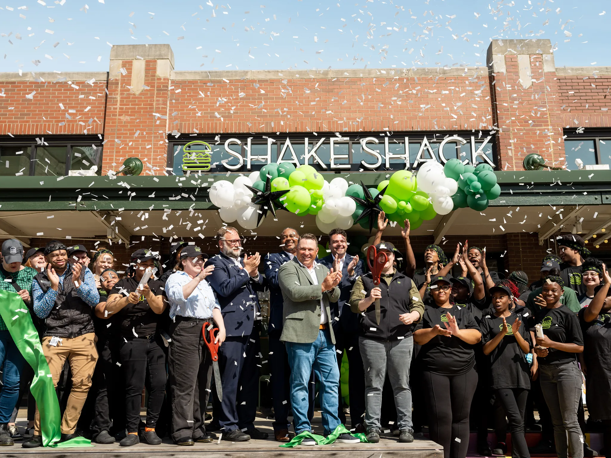 A Shake Shack grand opening celebration with employees and confetti