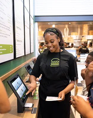 Shake Shack employee using a digital ordering system