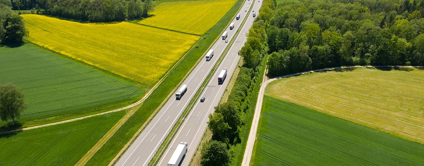 Vintage photo of an early Pilot gas station with attendants fueling a classic car beside a large sign advertising gas for 29 cents.