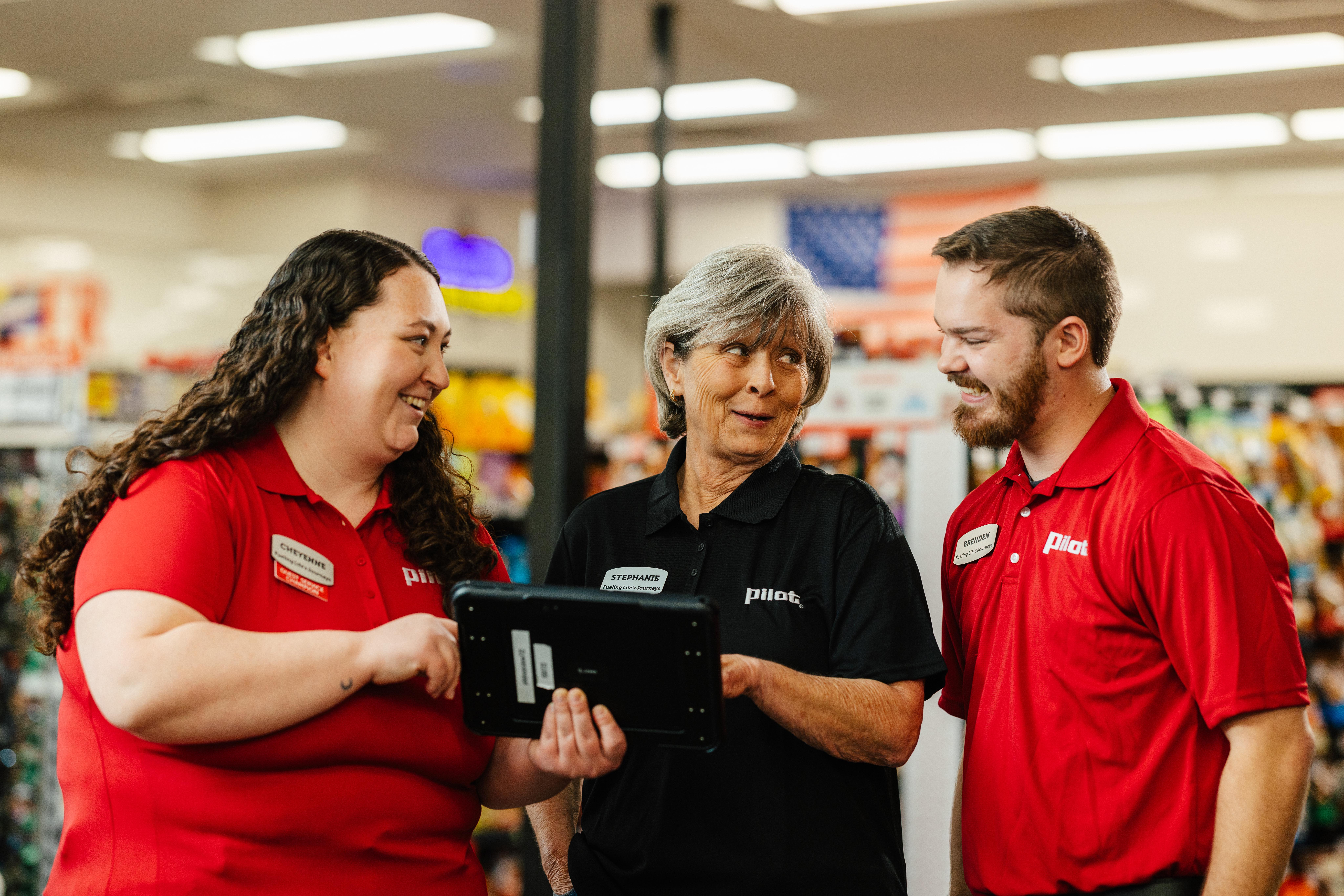An electric vehicle charging station at a Pilot Flying J travel center at dusk.