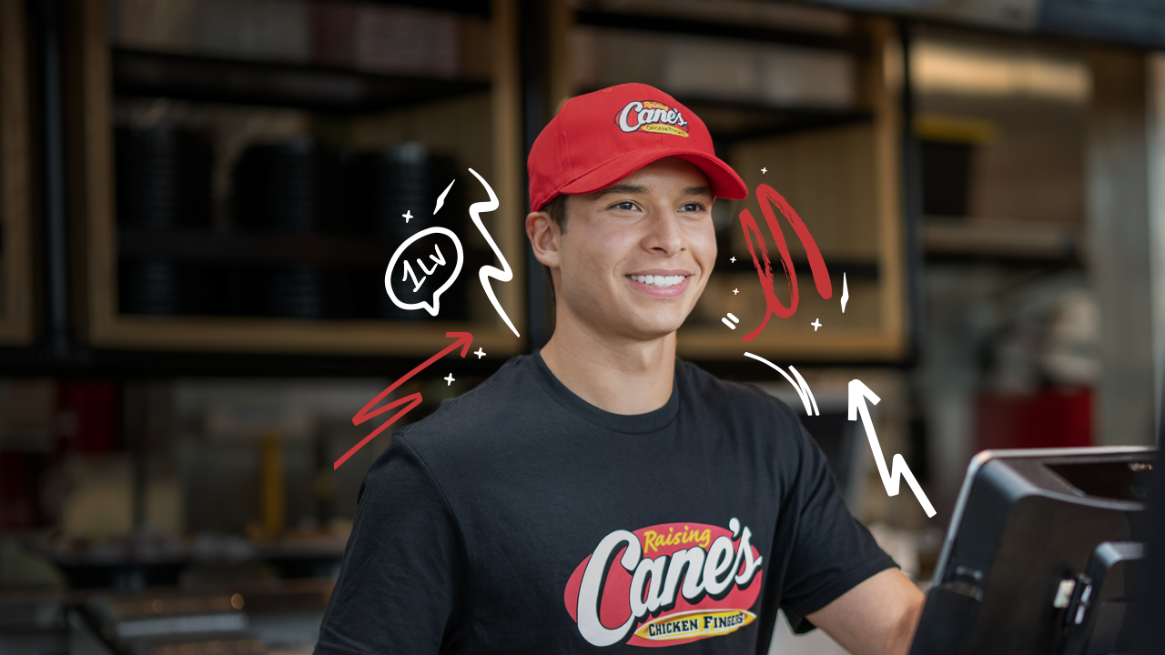 A male employee at Raising Cane's smiling