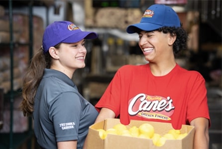 2 employees holding packages