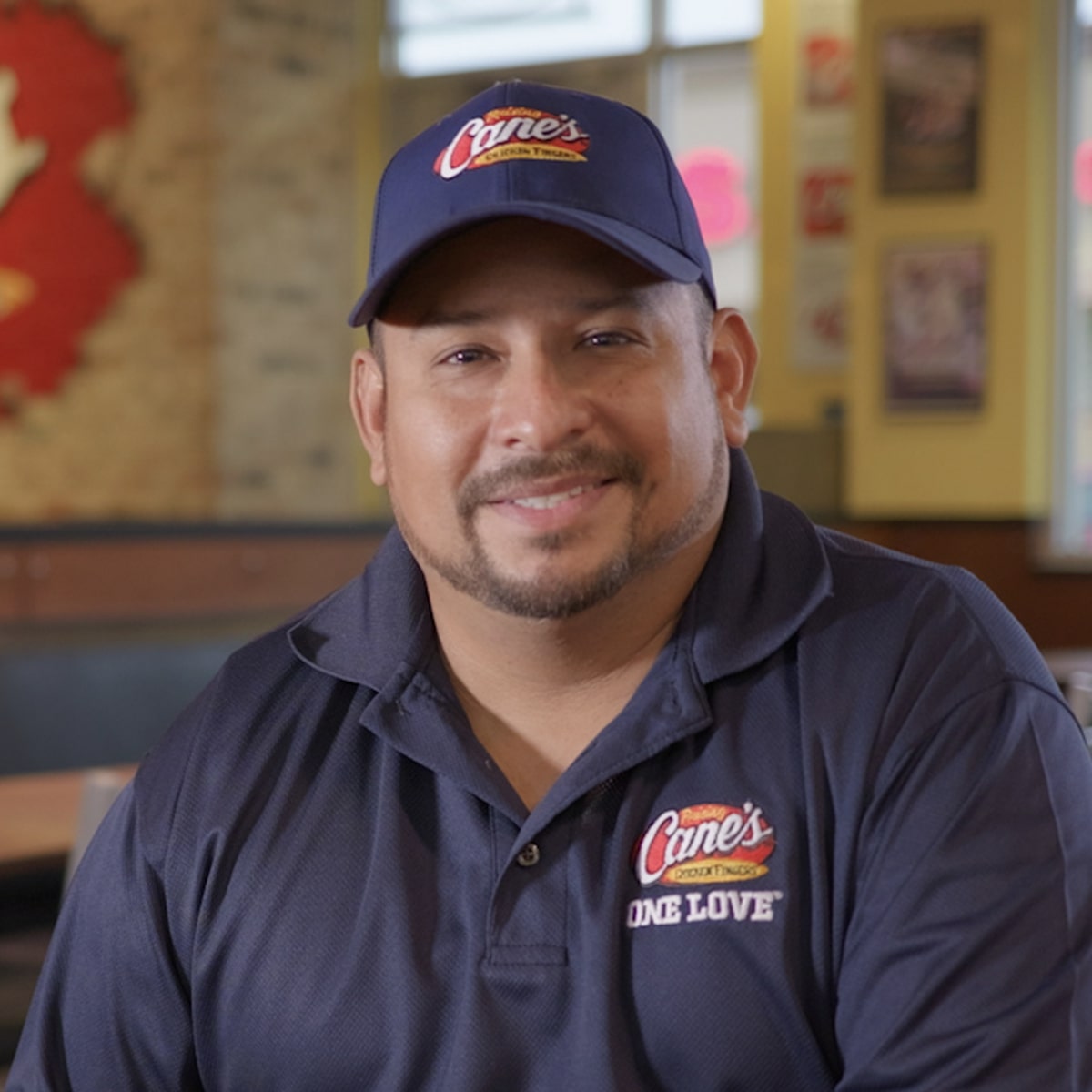 a man wearing a hat and a black shirt