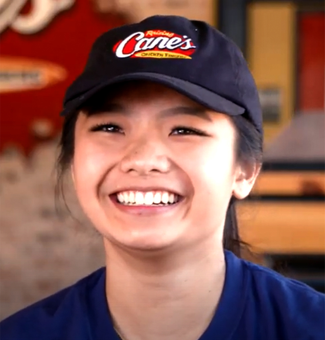 a woman wearing a cap and smiling for the camera