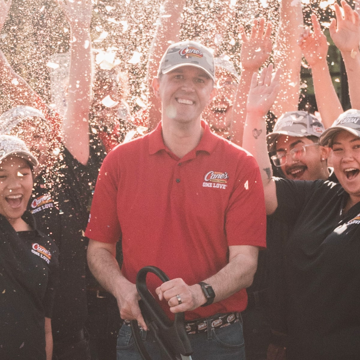 a male employee in a grand opening of a Raising Cane's restaurant