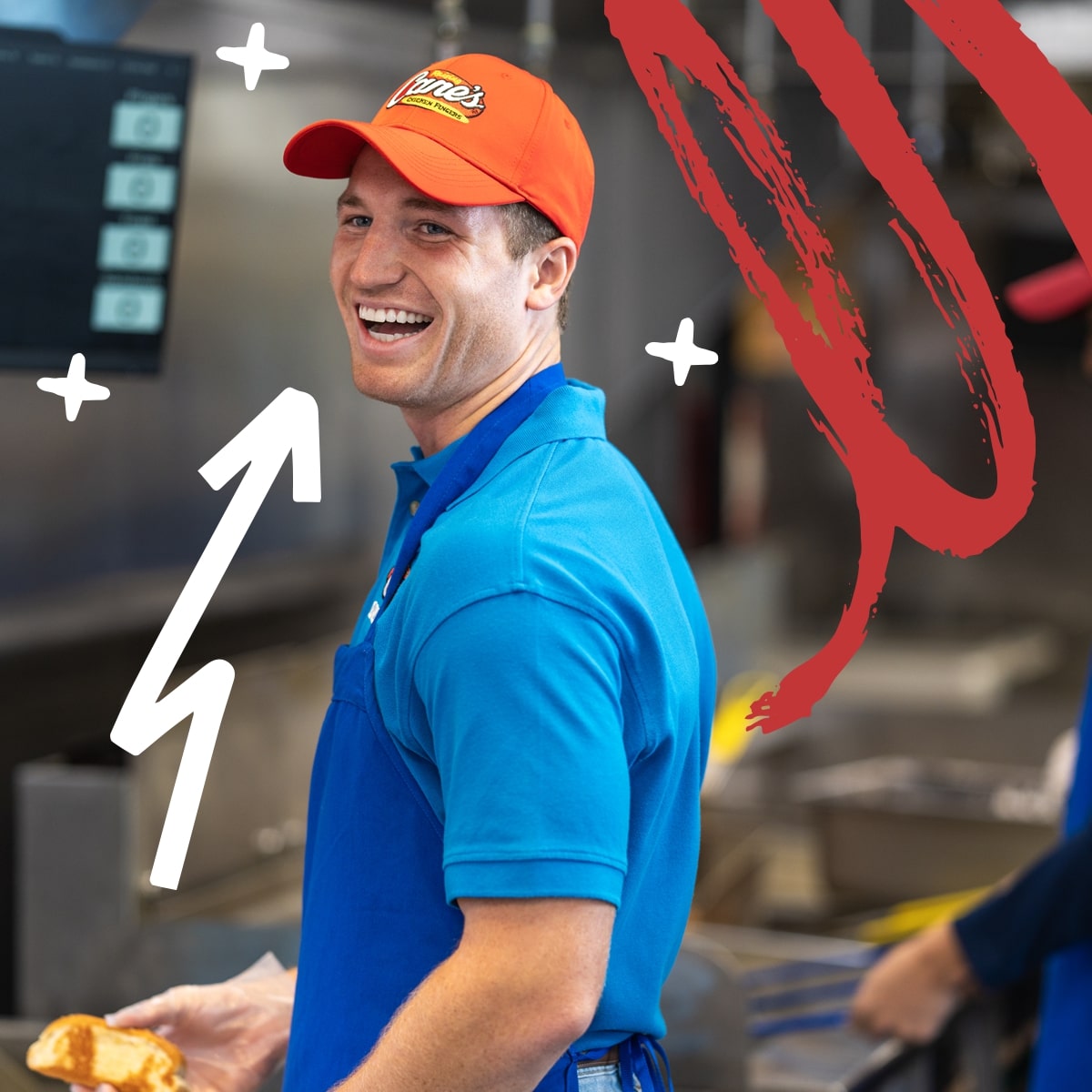 A male employee at Raising Cane's laughing