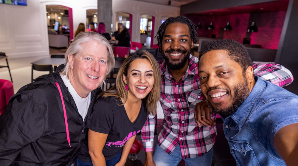 four T-mobile employees smiling