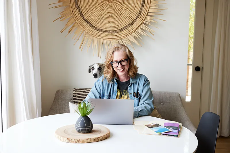 A woman is working at the computer.