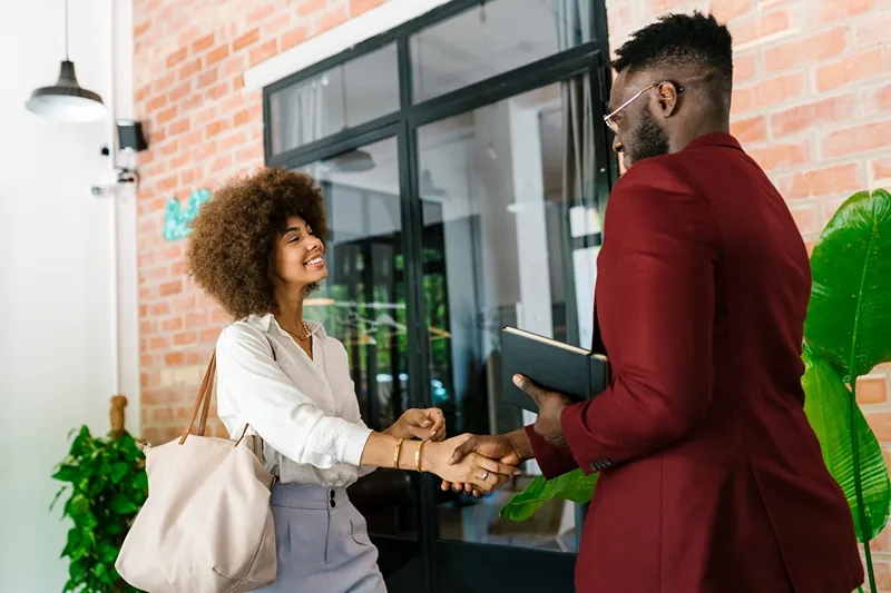two employees shaking hands