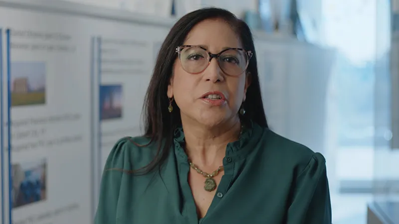Woman wearing glasses speaking