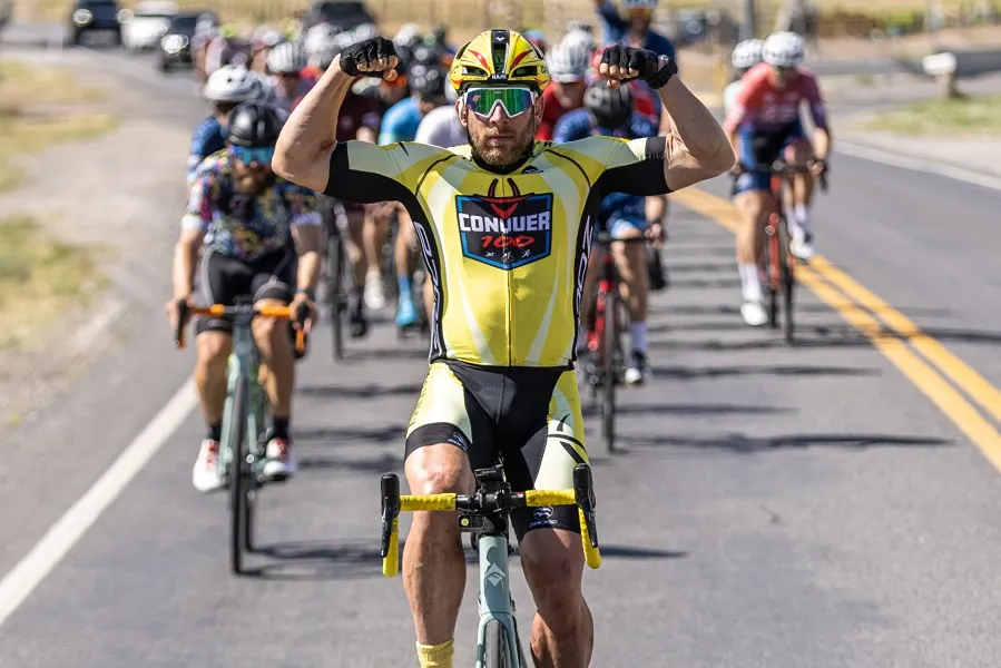 a man in a bicycle competition, showing off his muscles