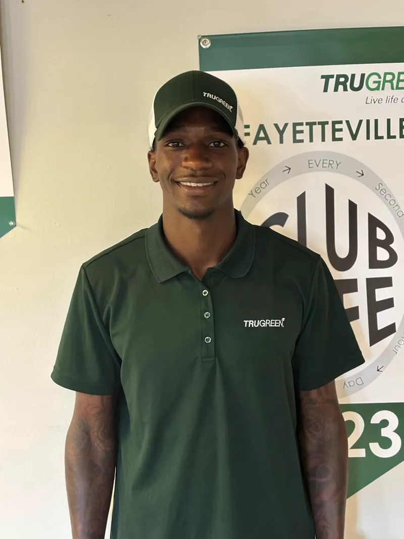 Trugreen employees are talking about the fence with a customer