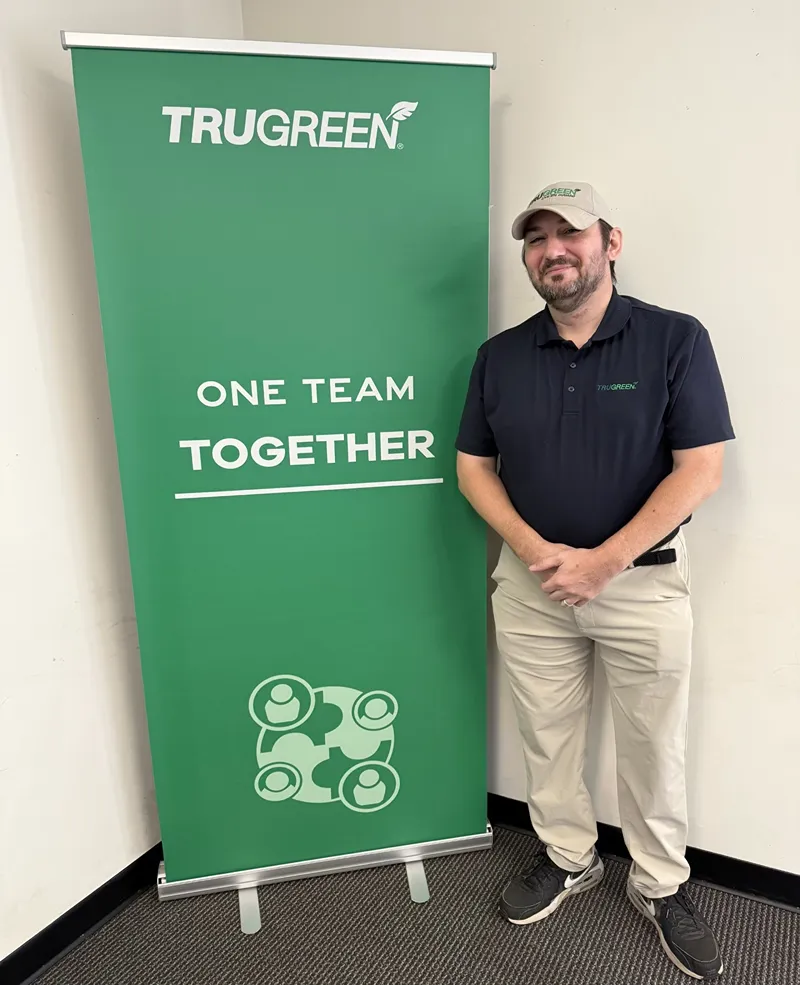 A men next to the banner