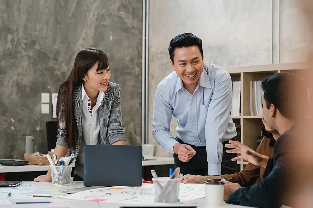 a man discussing with his colleagues in a meeting