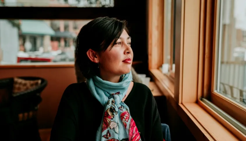 A woman looking outside the window