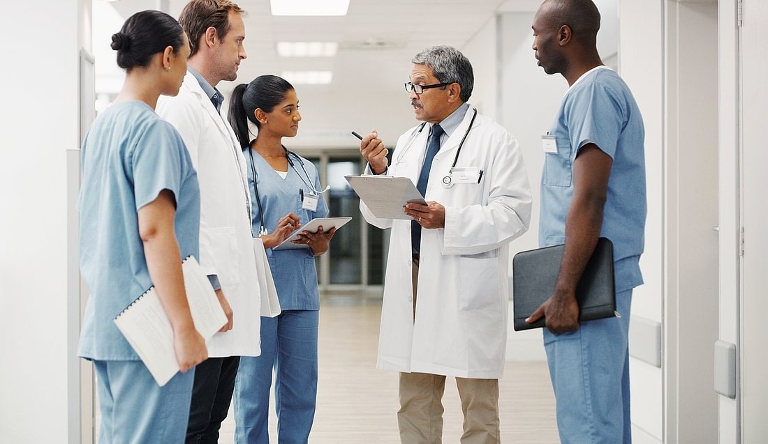 Group of doctors and nurses talking in the corridor