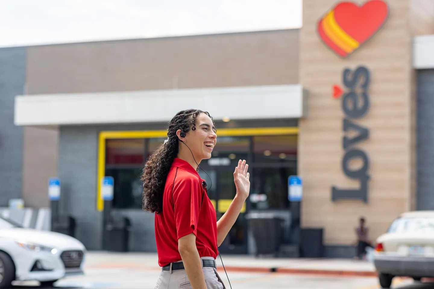 Hero image for Love's Travel Stops Careers, showcasing a smiling employee ready to assist customers.