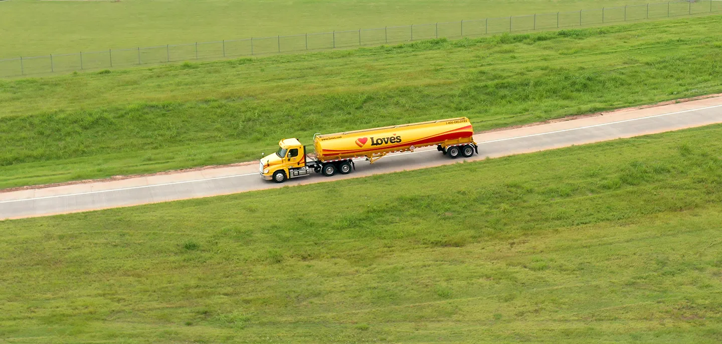 Hero image for CDL Driver careers, featuring a Love's truck on an open highway at sunset.