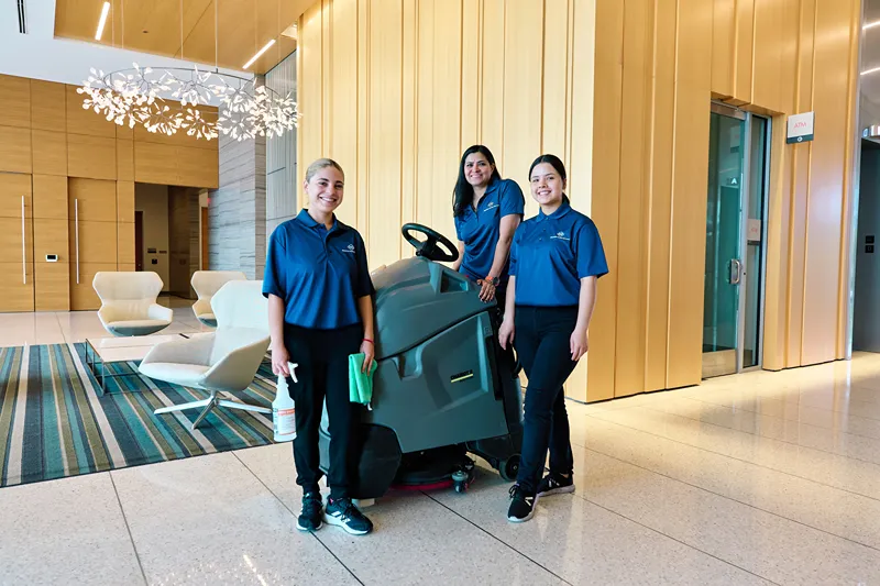 2 people are driving the floor cleaning machine