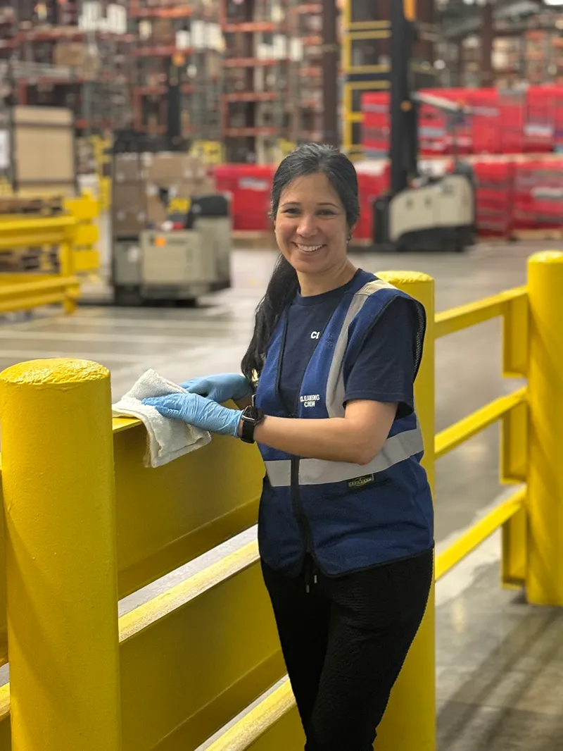 A dedicated KBS crew member performing cleaning duties in a commercial building, showcasing the heart of the team.