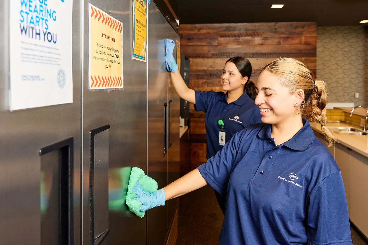 A woman and a man are on a cleaning machine.