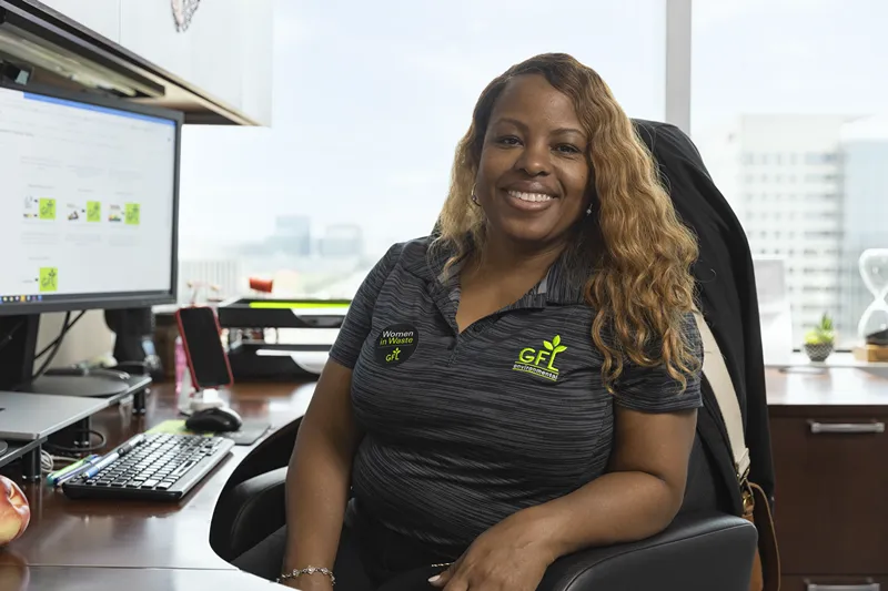 Smiling woman sitting at her desk in an office