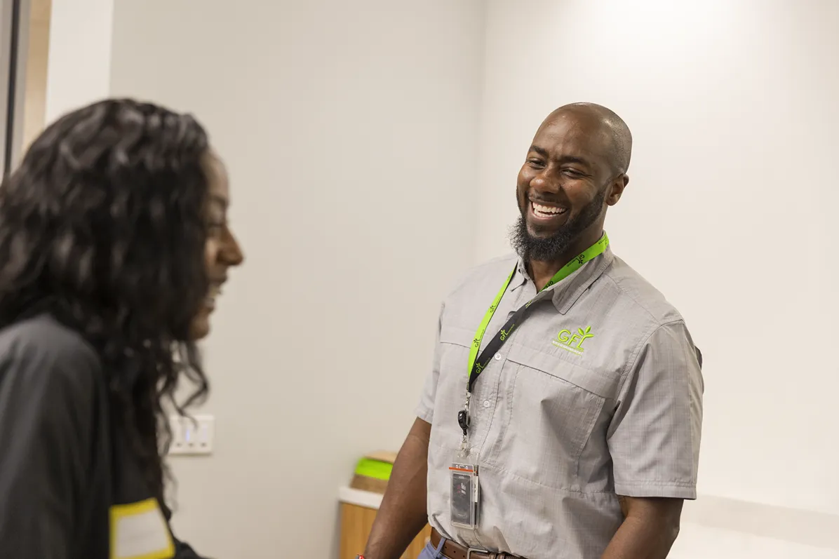 A smiling man and woman talking during a co-op and intern opportunities meeting