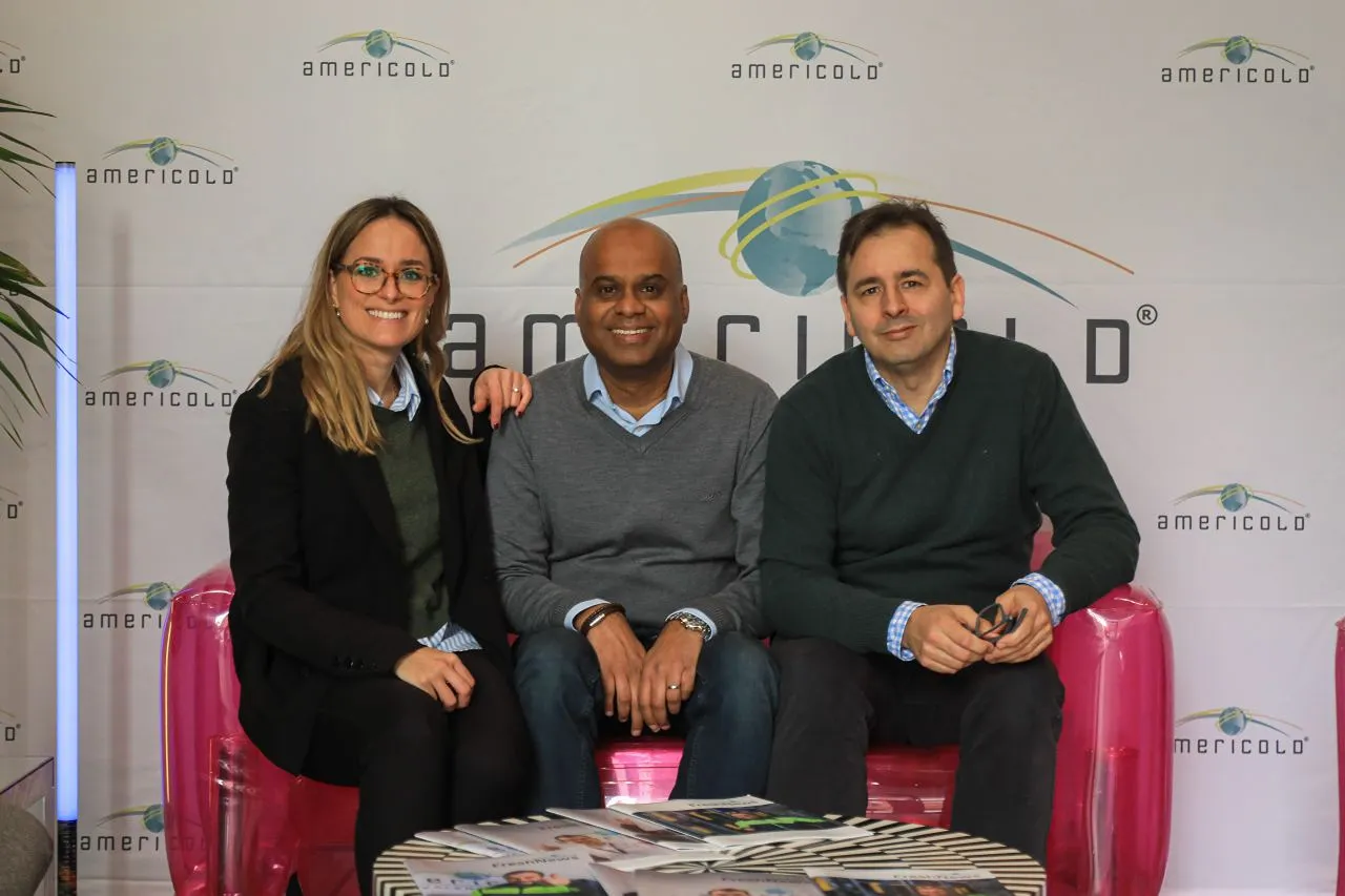 Americold leaders smiling during the Leadership Academy event, seated in front of the branded backdrop.
