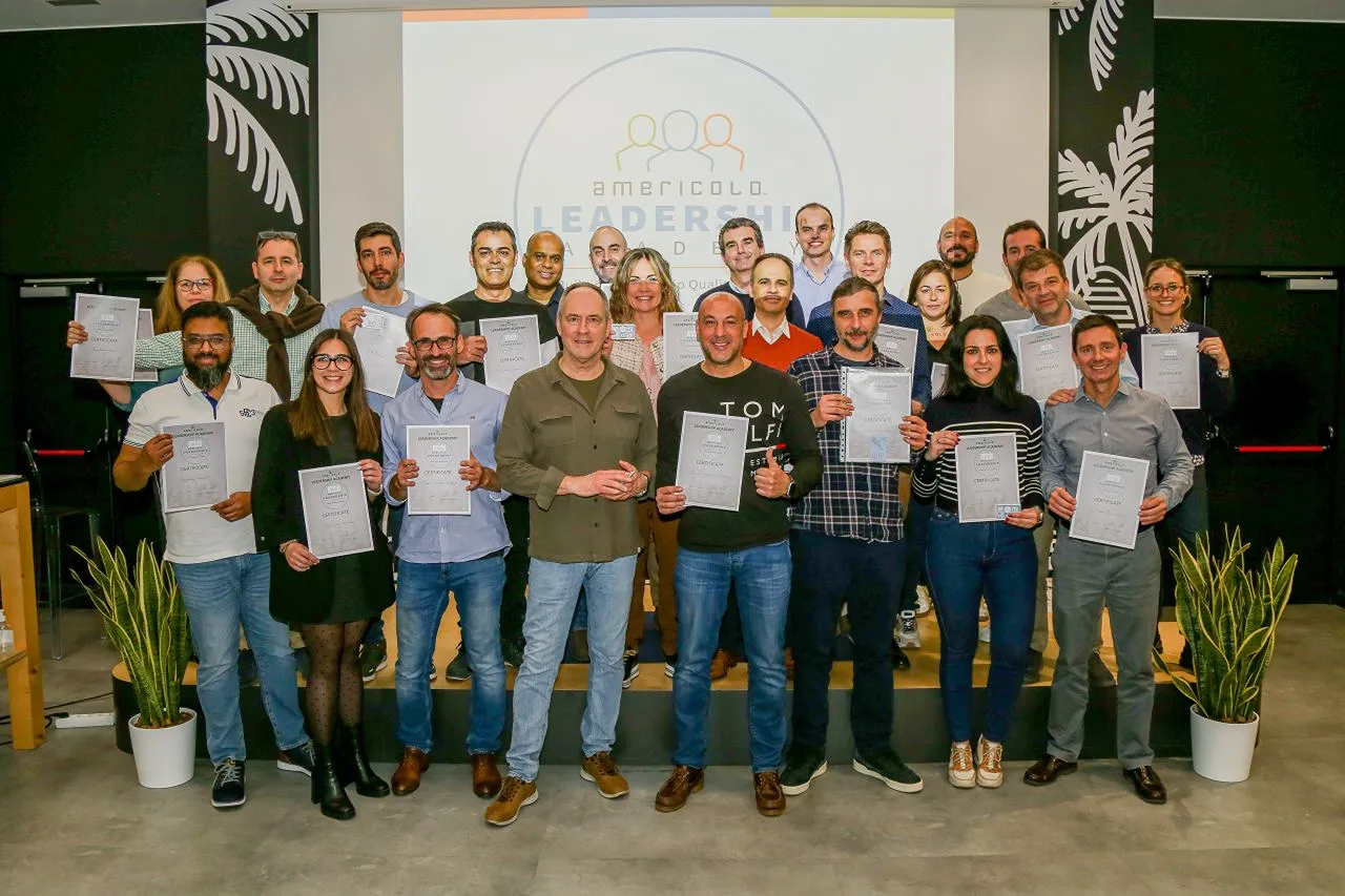 Team photo of Americold Leadership Academy graduates proudly holding certificates after completing the leadership program.