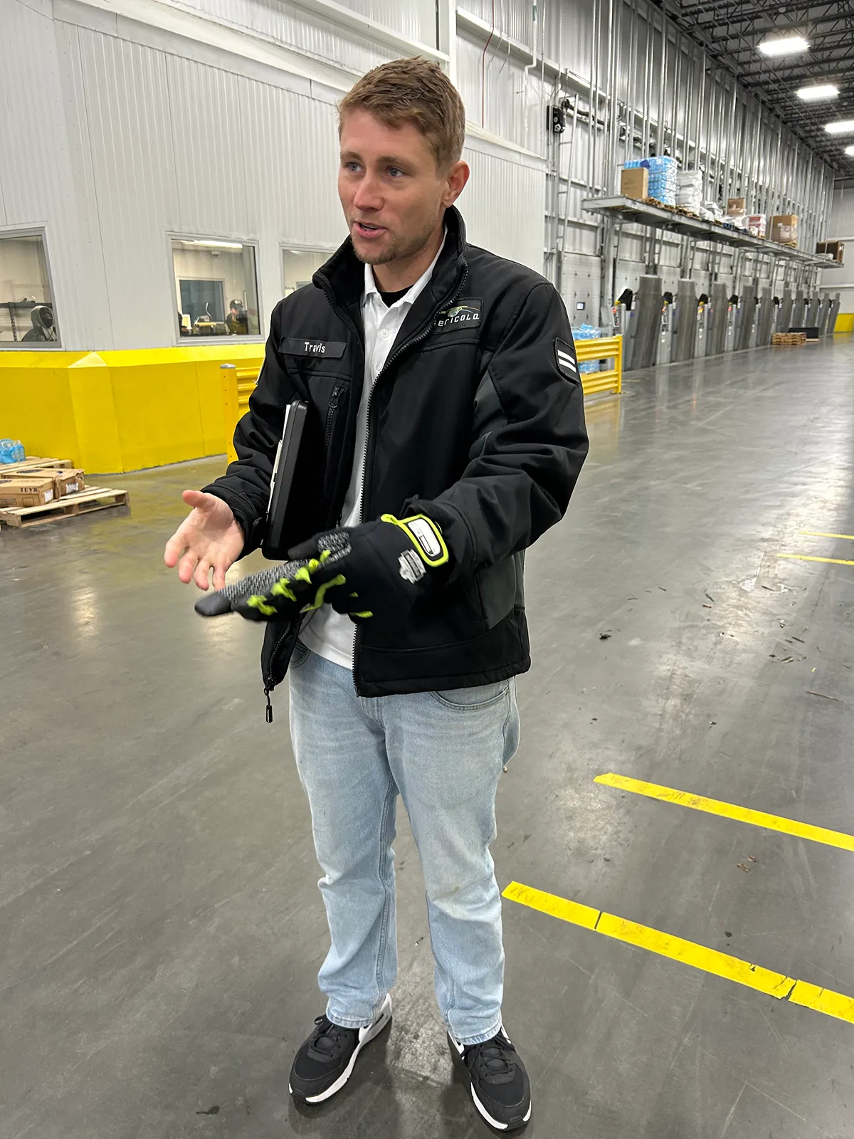 A manager walks through the warehouse with an employee, providing guidance and executing the leader program.