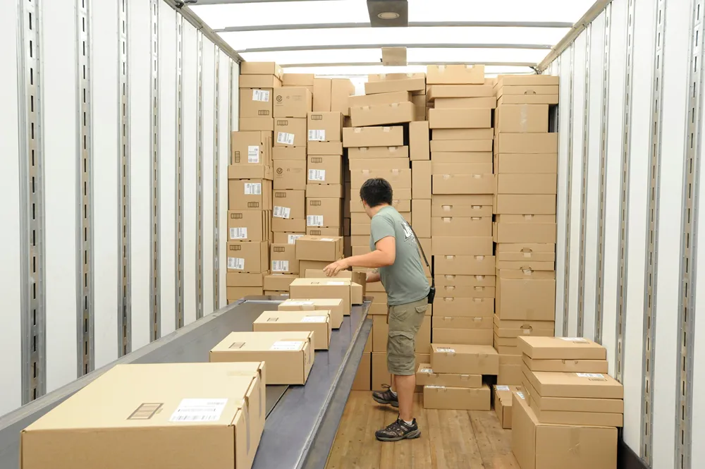 a man is loading boxes into a truck