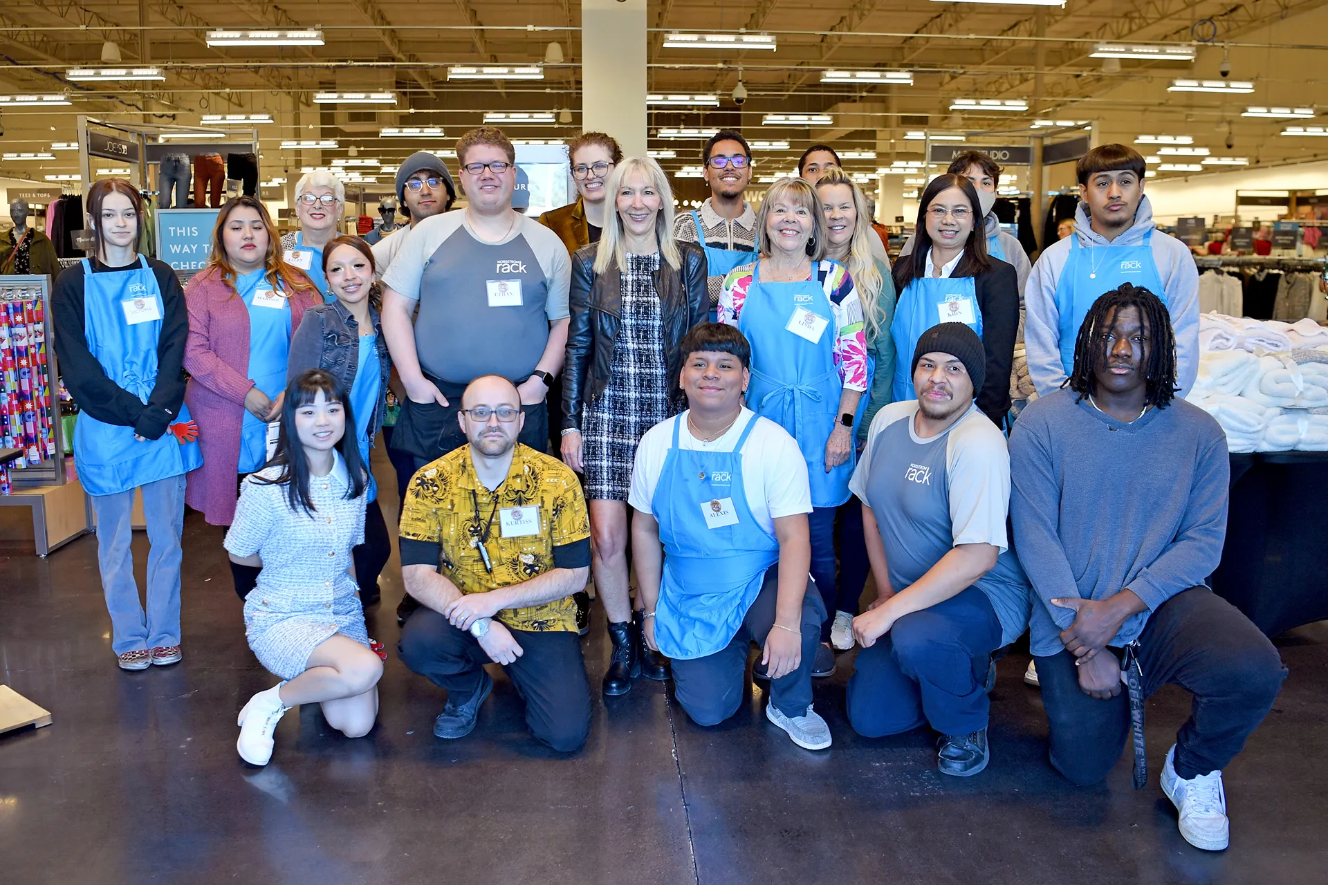 a group of people in Nordstrom shirts posing for a photo
