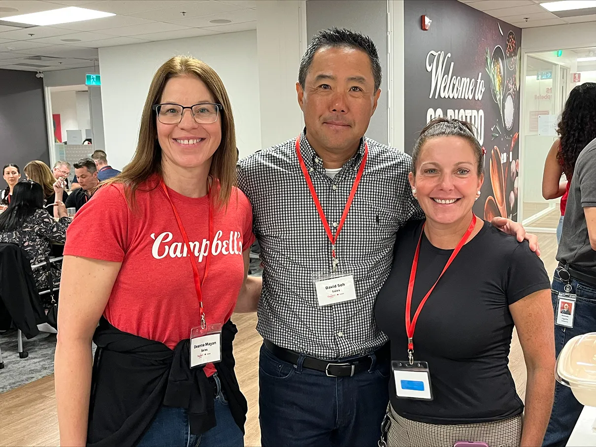 Three Campbell's employees group photo