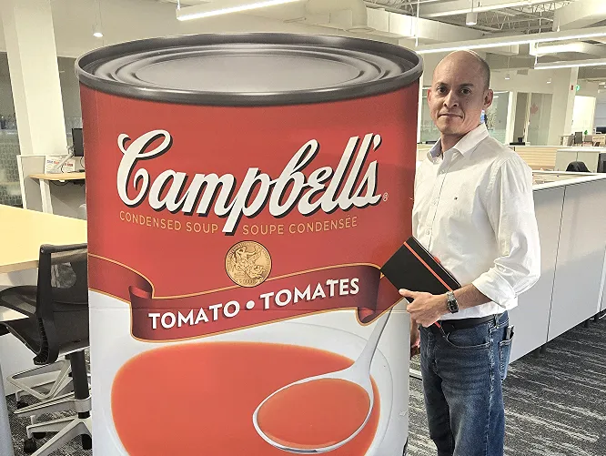 Rolando with a hug Campbell's Tomato + Tomates can