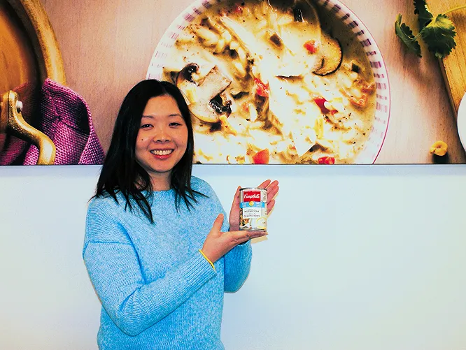 Angela holding a Campbell's can on their hands