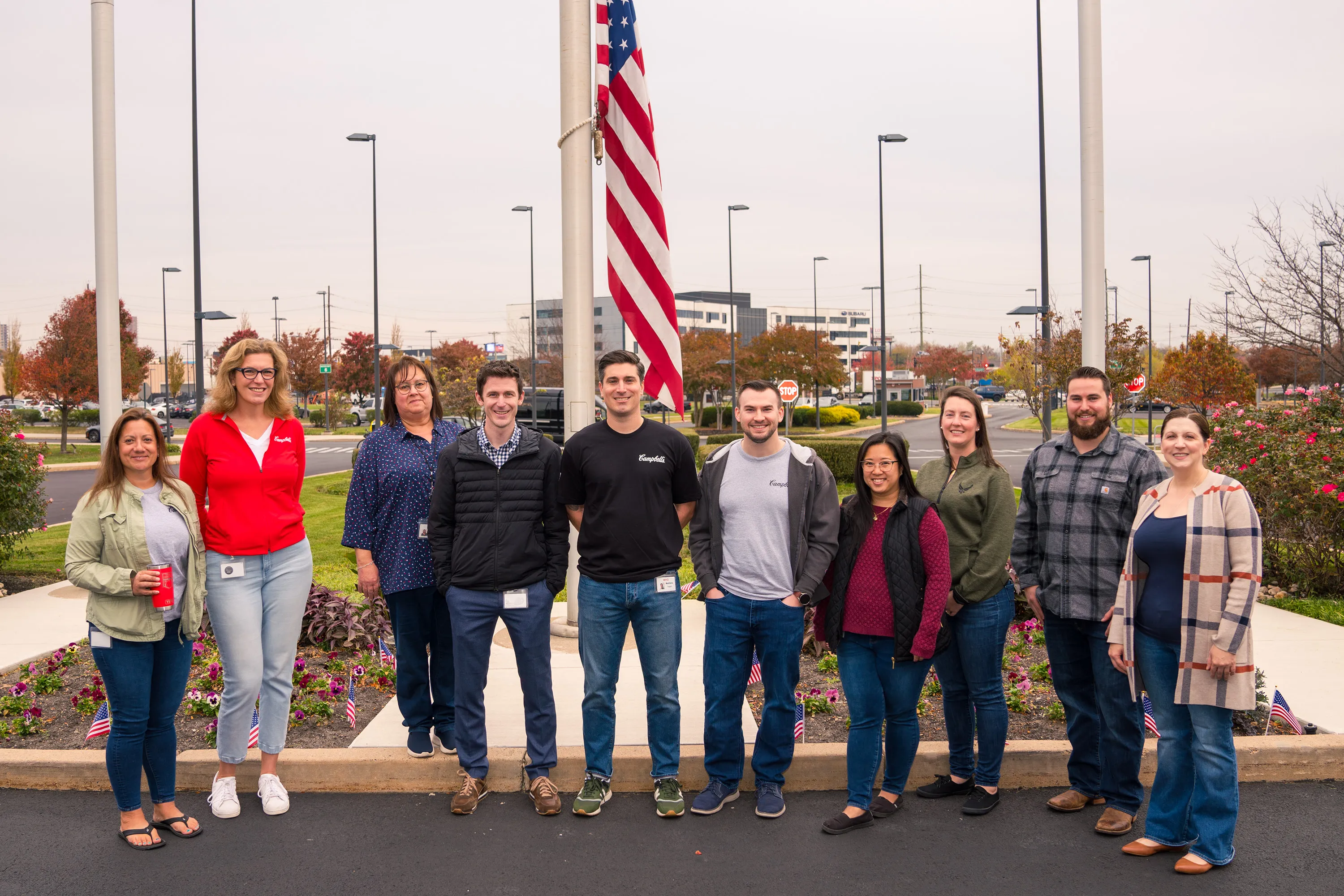 Team photo of employees in front of an American flag