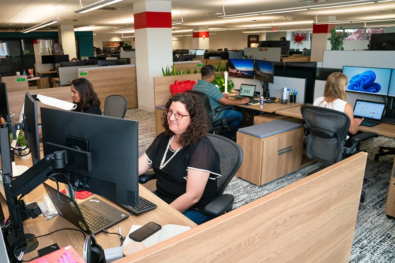 Administrative staff working at computers in a modern office