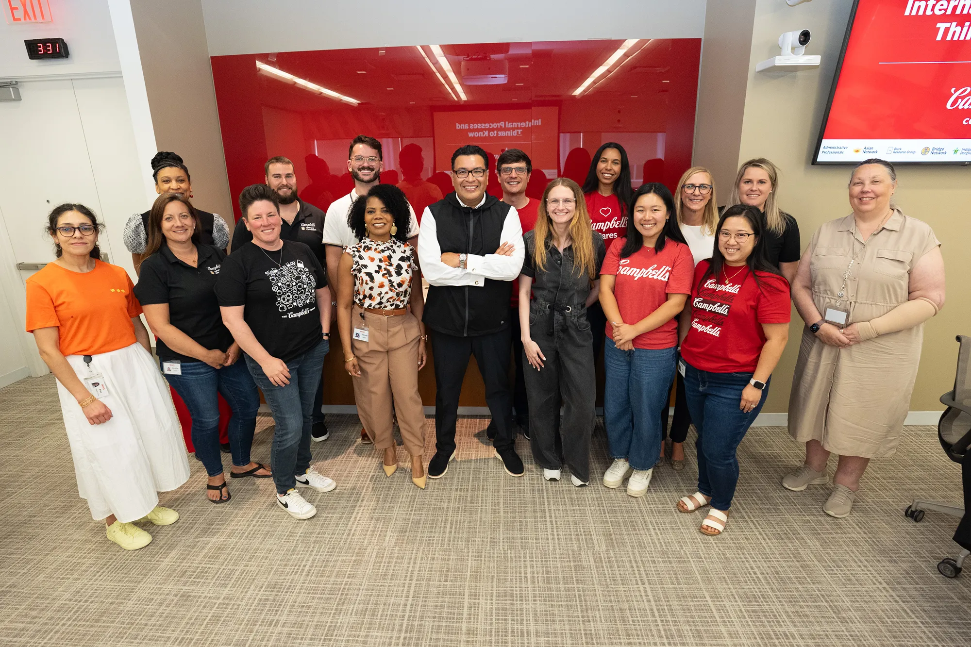 A diverse group of Campbell Soup Company employees pose for a photo showcasing a culture of inclusion
