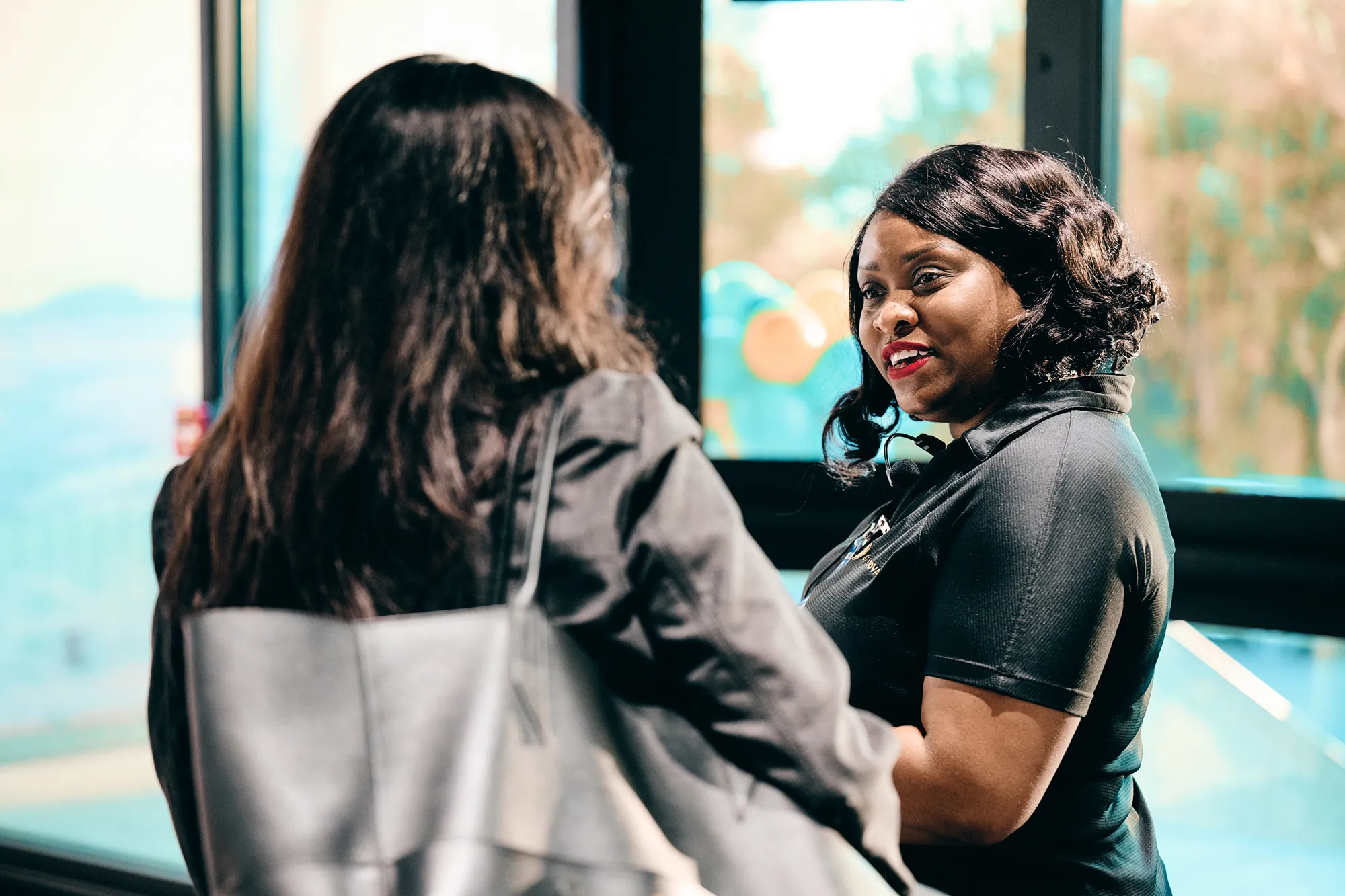 Two people speaking inside of an office building